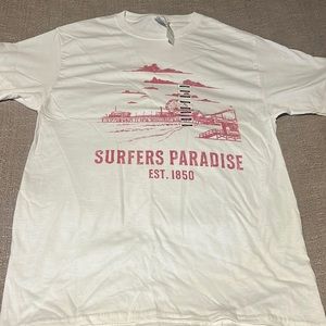 White shirt with pink graphic on it